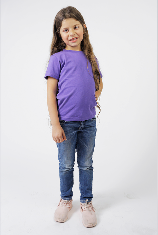 A young girl wearing a Suna Cotton® Purple Toddler Tee