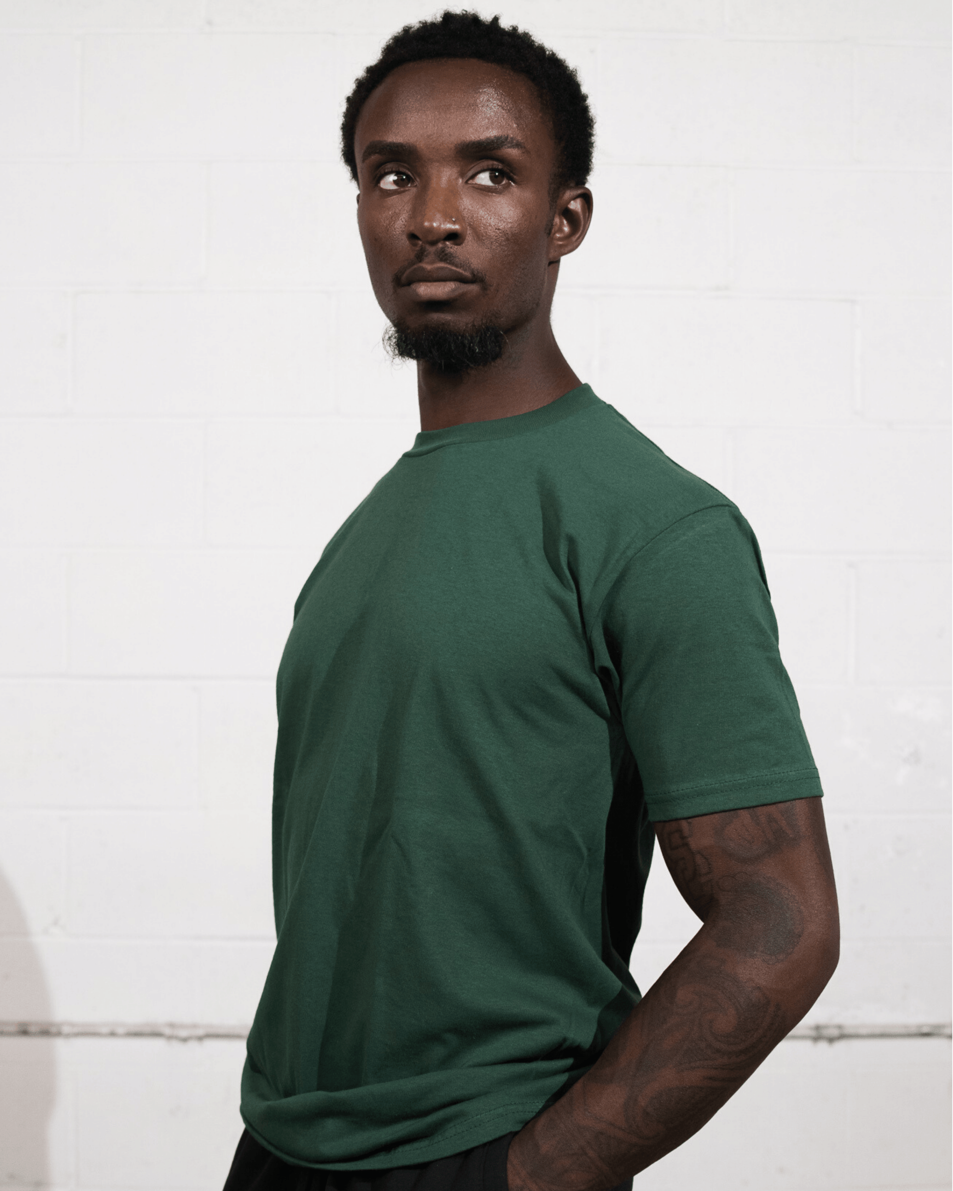 A man wearing Forest Green Suna cotton Forest Green t-shirt