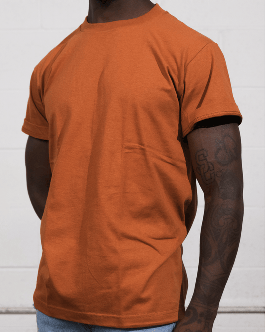 A man wearing a Texas Orange Suna Cotton® Adult T-shirt