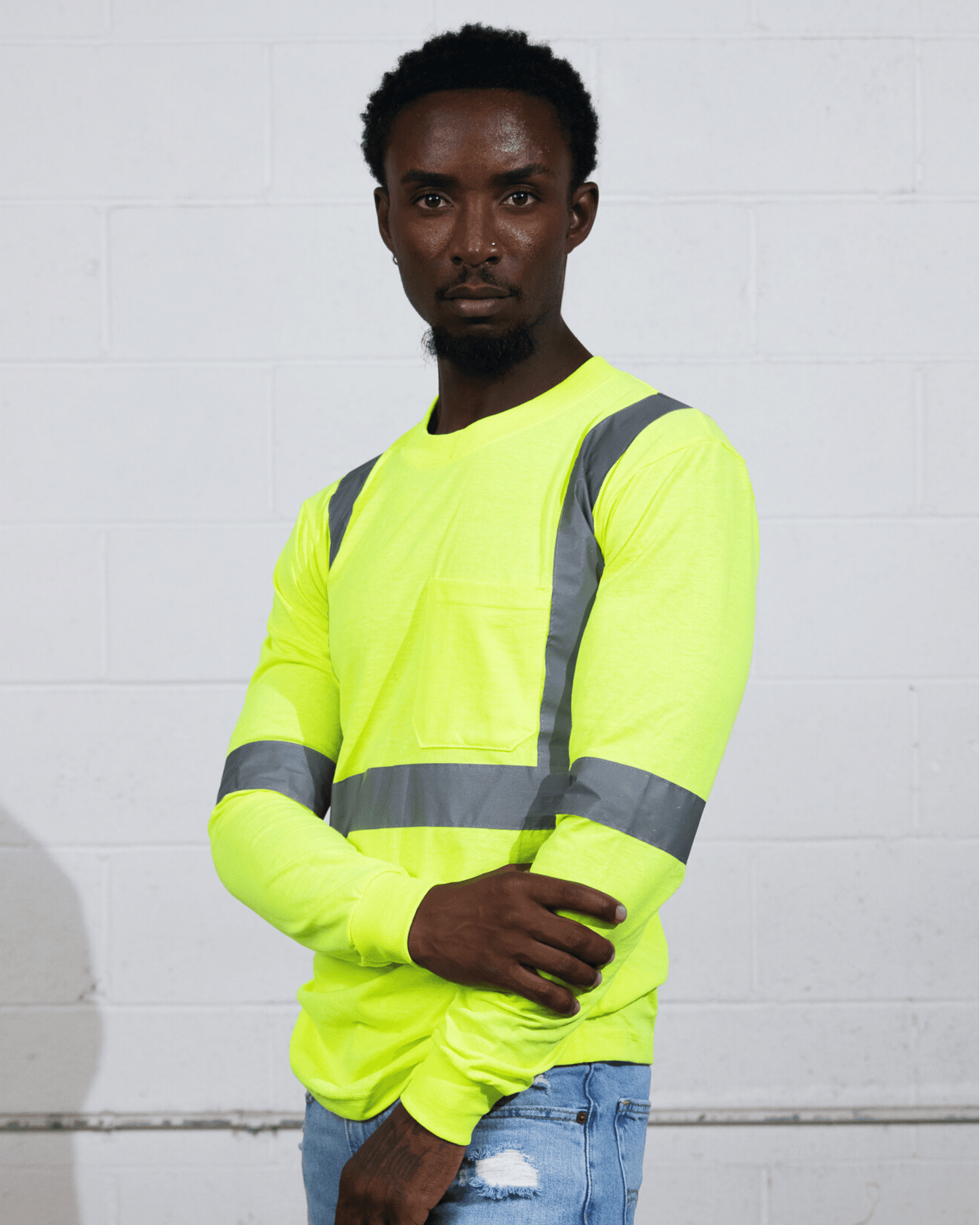 Man wearing a Suna Cotton® Safety Green Long Sleeve Reflective T-shirt