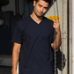 A man wearing a Navy Blue Suna Cotton® Adult V-neck T-shirt