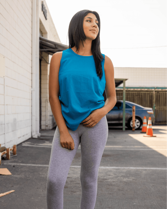 A woman wearing Turquoise Suna Cotton® Adult Tank Top